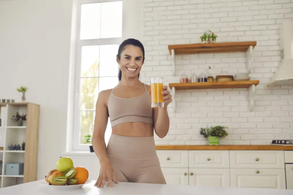 woman holding a pre-workout drink