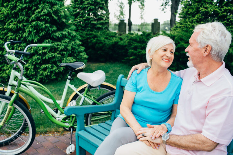 two people sitting on a bench in the park thinking about anti-aging solutions