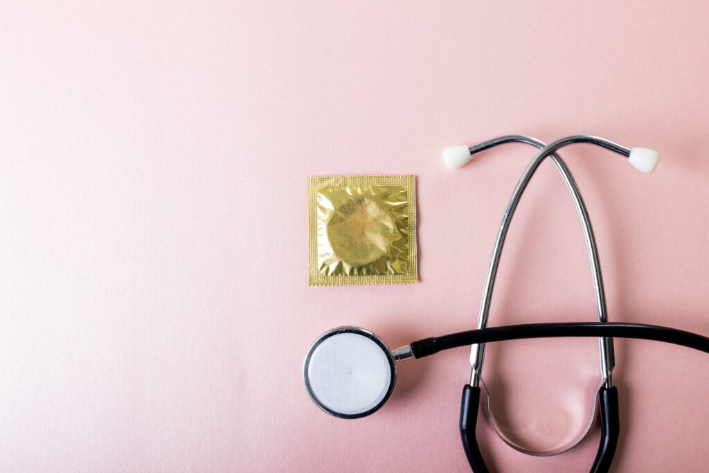 condom next to a stethoscope to promote STD testing