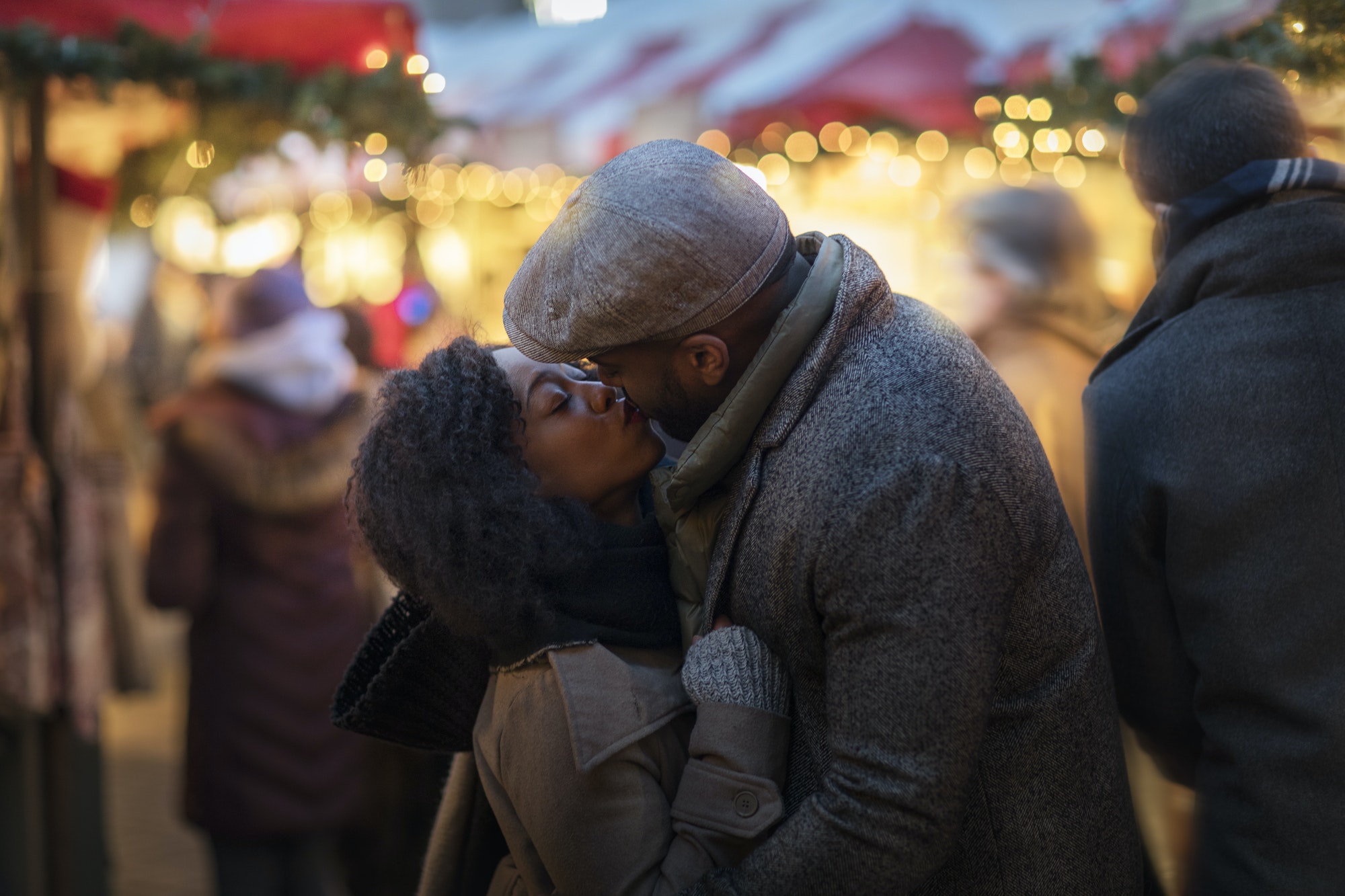 Romantic couple kissing at Christmas market, New York, USA