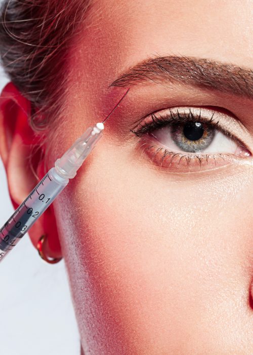 close-up of a woman doing an injection under the eyebrow